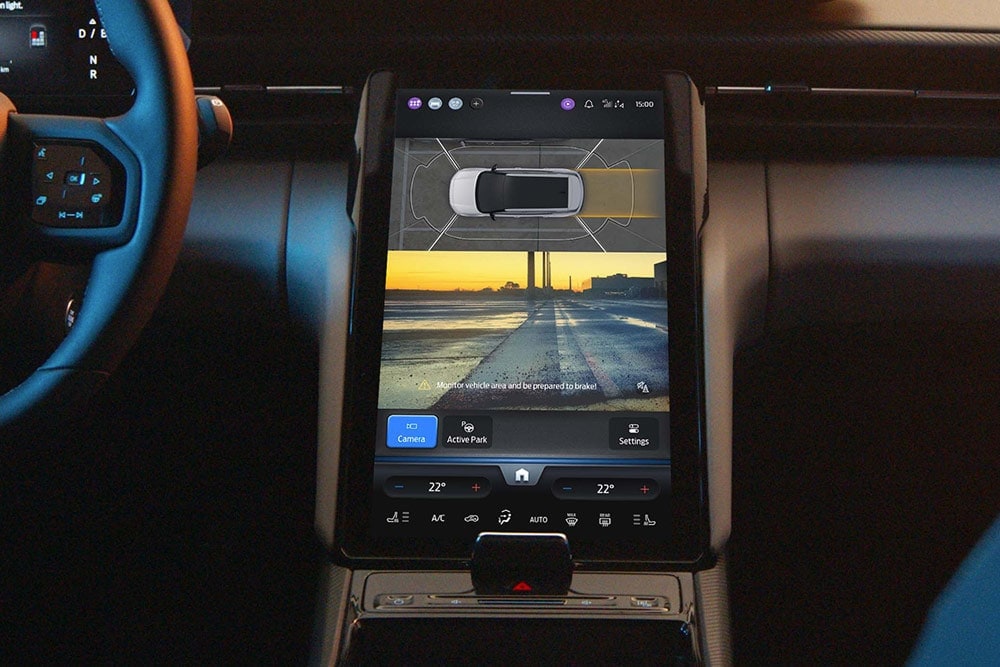 Close-up of a Ford SUV digital touchscreen showing the Active Park Assist system in use.