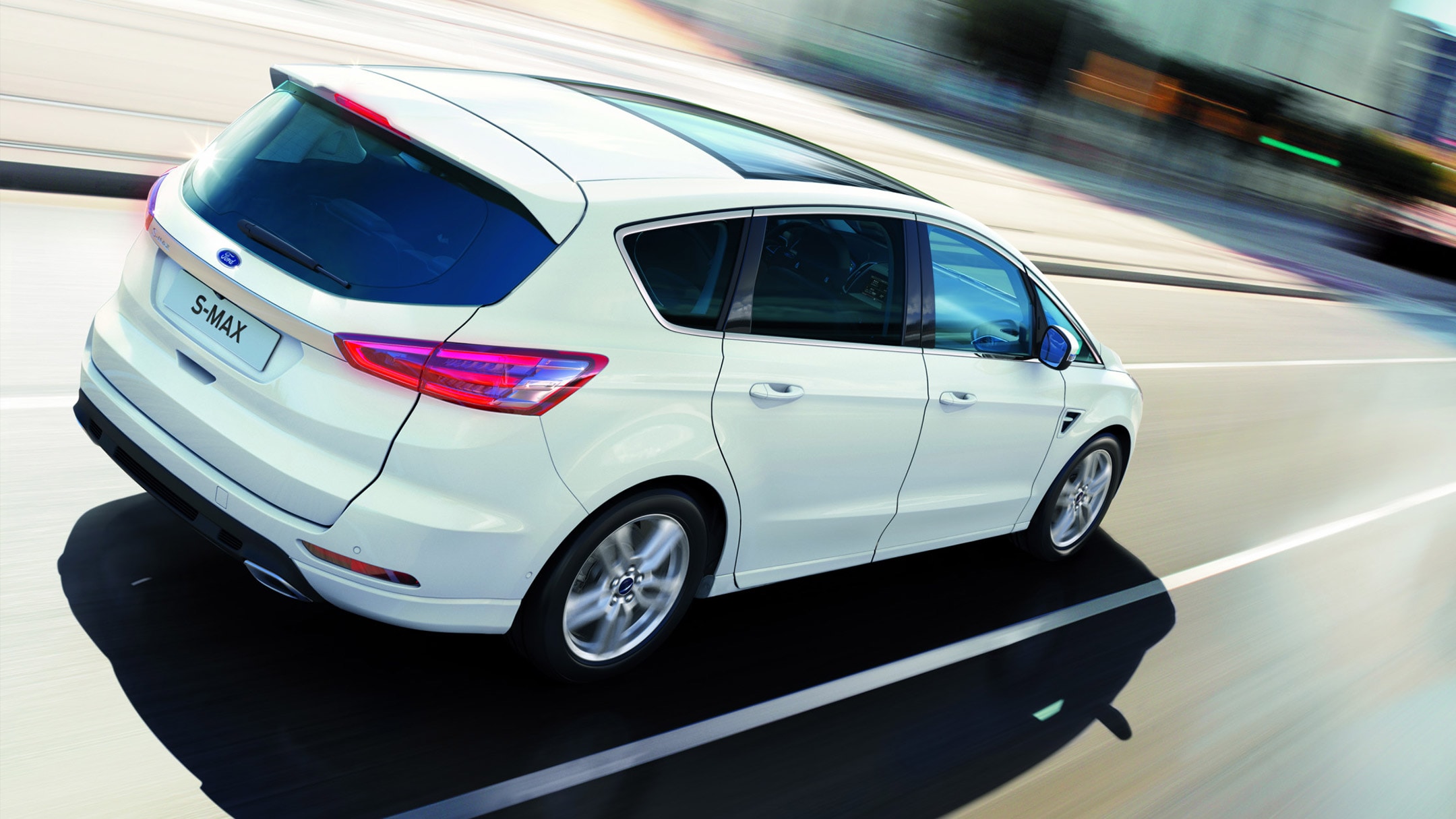 White Ford S-MAX in motion in the city