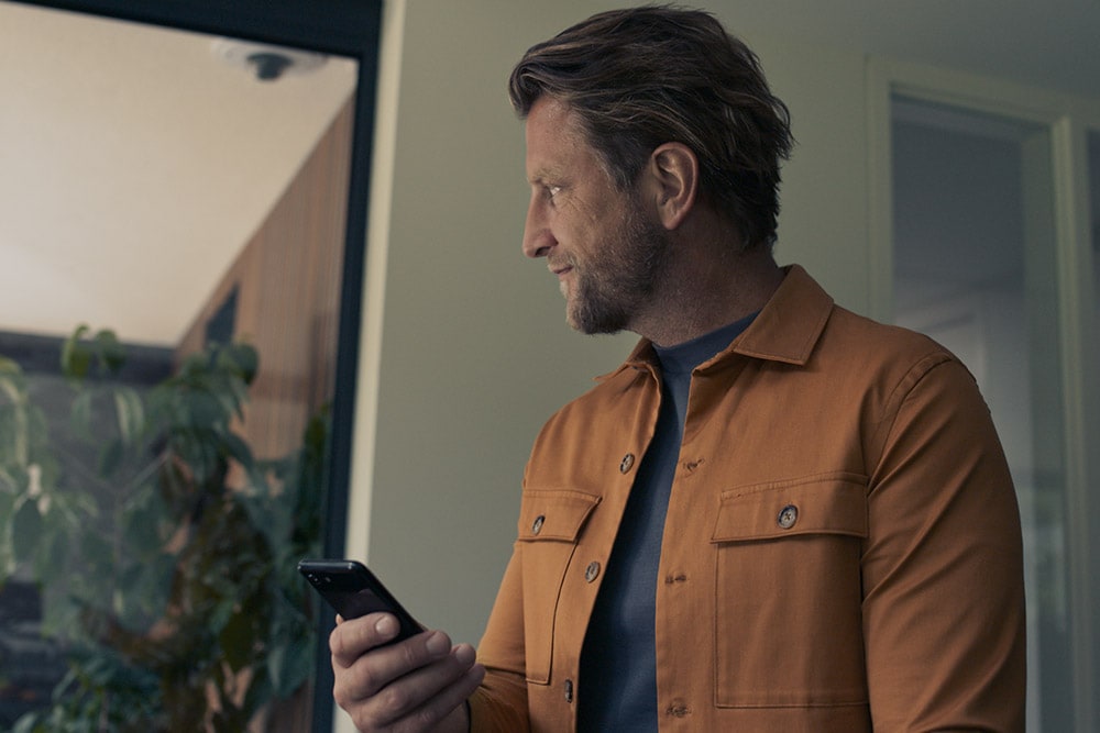 Man With Phone in Yellow Jacket