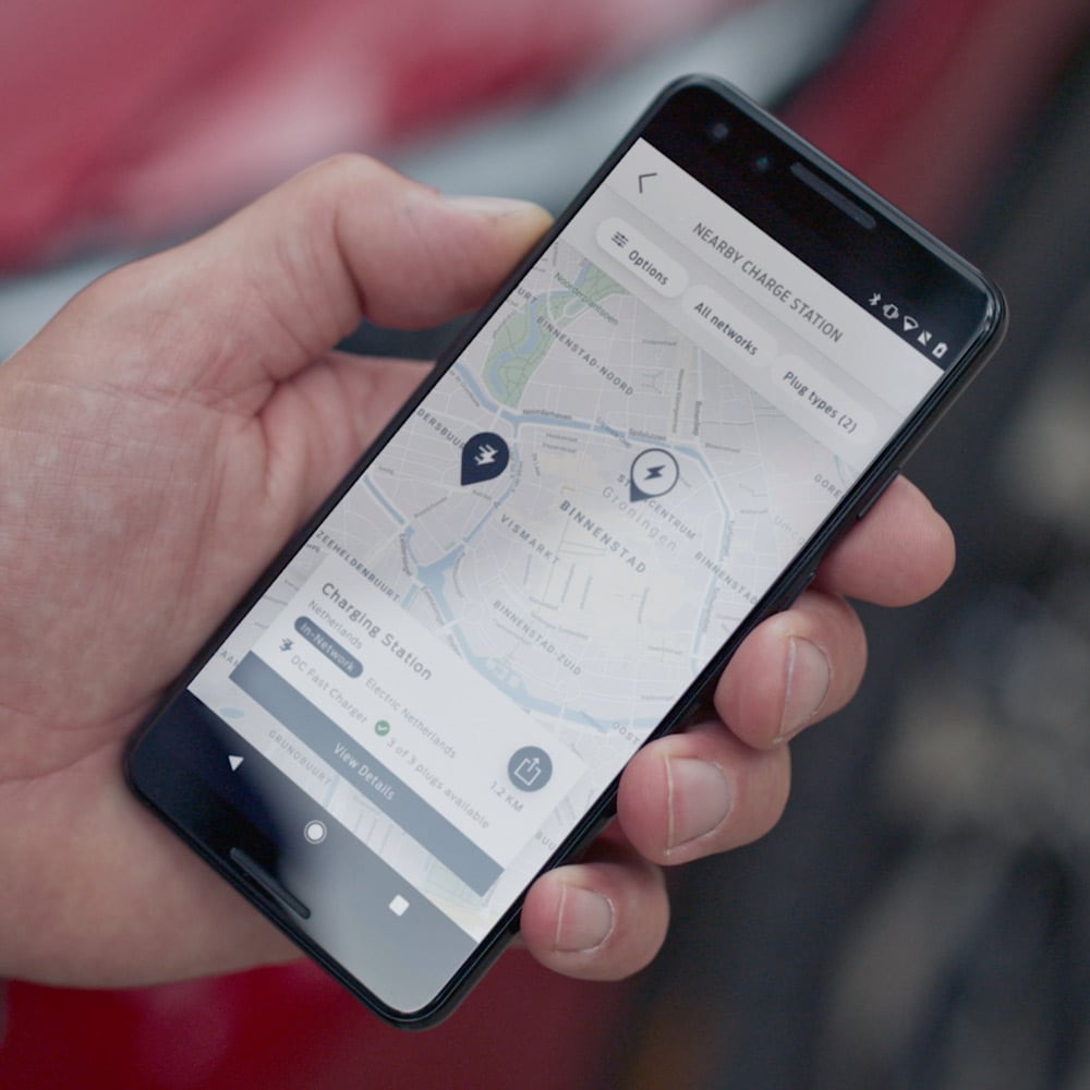 A person using the FordPass app on a smartphone