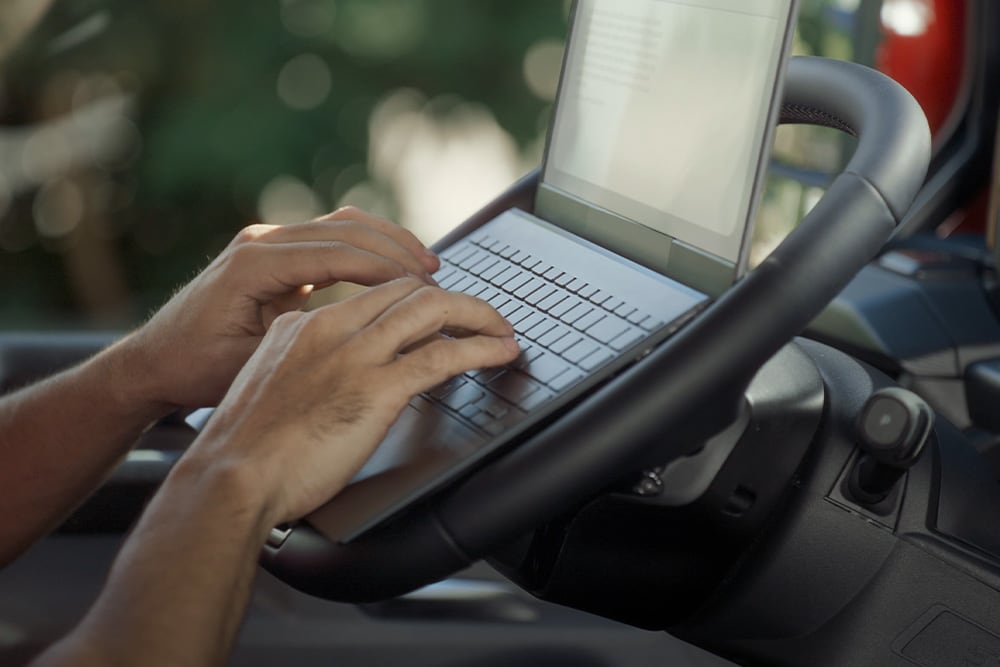 Person using laptop inside the Tourneo Custom