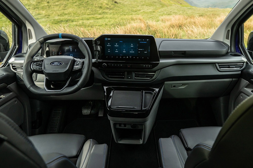 The interior dashboard, centre console and steering wheel of the Ford Tourneo Custom MS-RT.