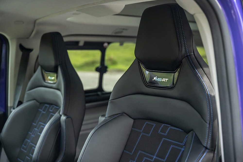Black leather and suede front seats with blue contrast stitching and MS-RT logo on head rest in Ford Tourneo Custom MS-RT.