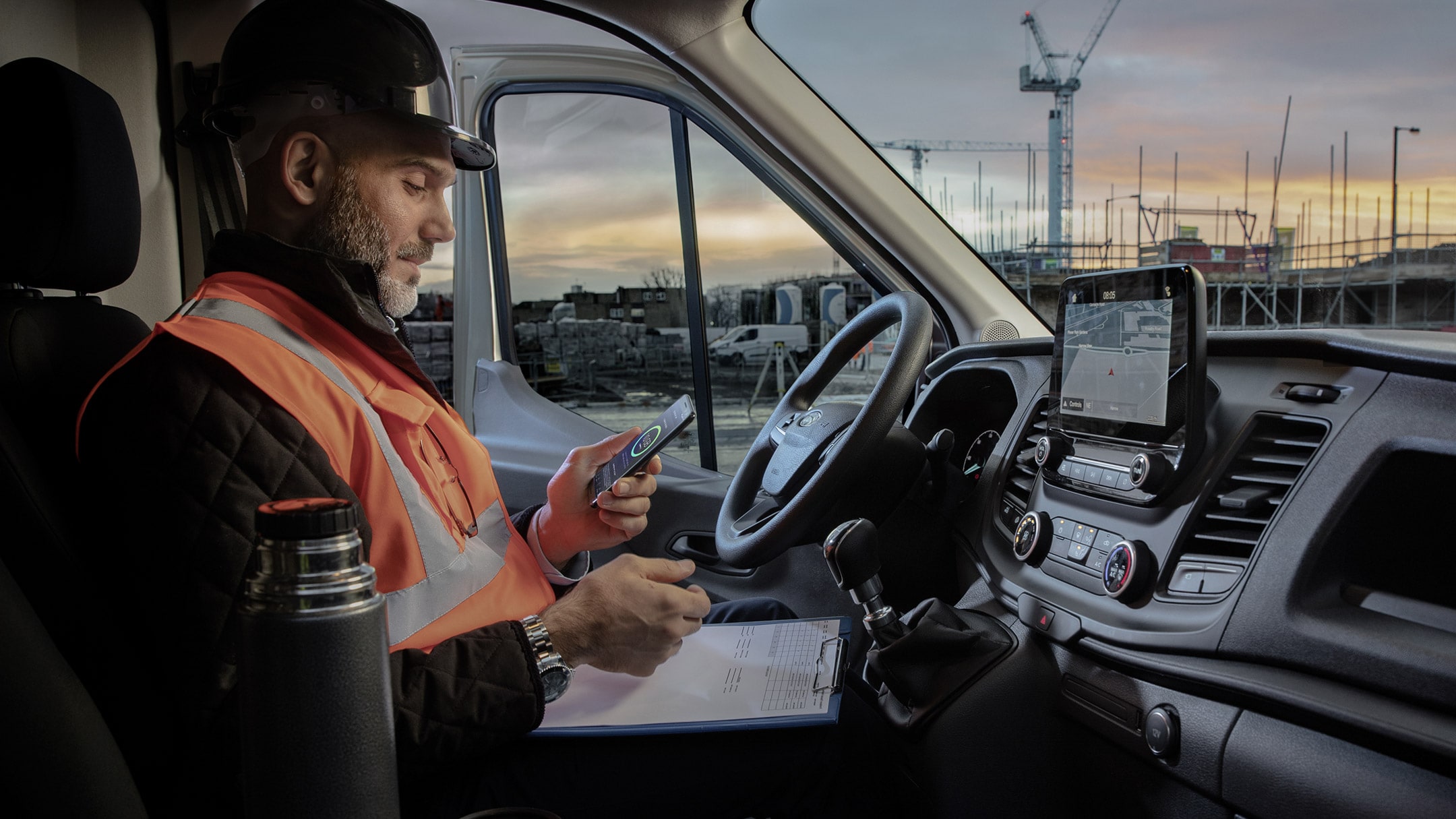 Man with mobile showing FordPass Connect