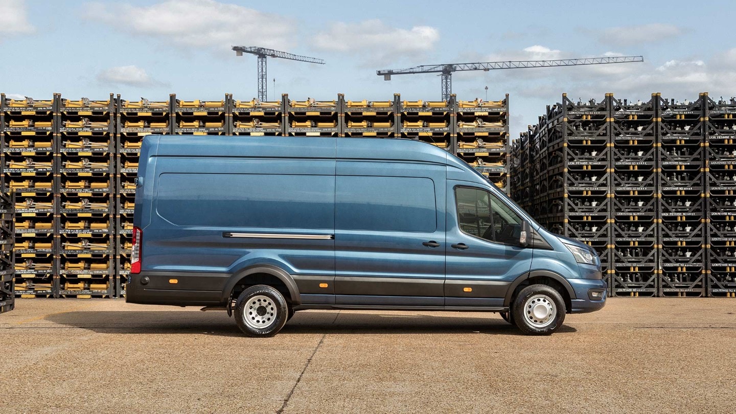 Blue Ford Transit Van near construction