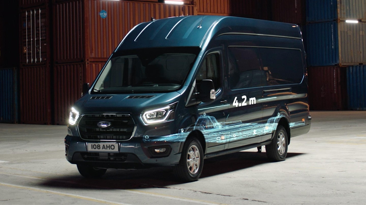 Ford Transit Van parked next to containers