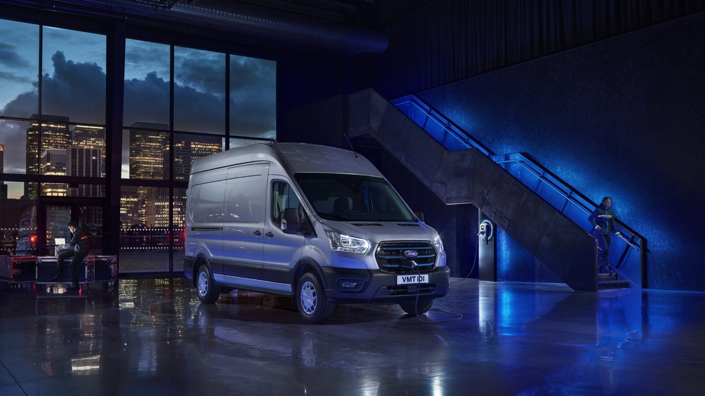 E-Transit parked in showroom with blue lights at background