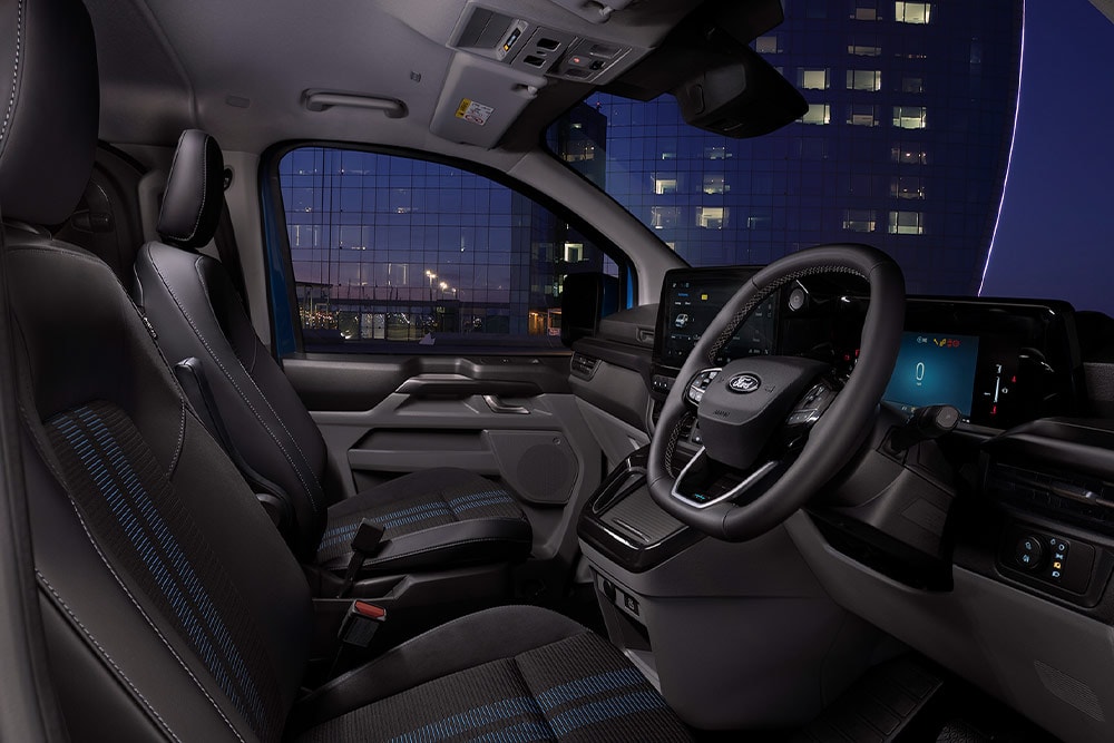 Interior of Ford E-Transit Custom electric van, driver and passenger seats.