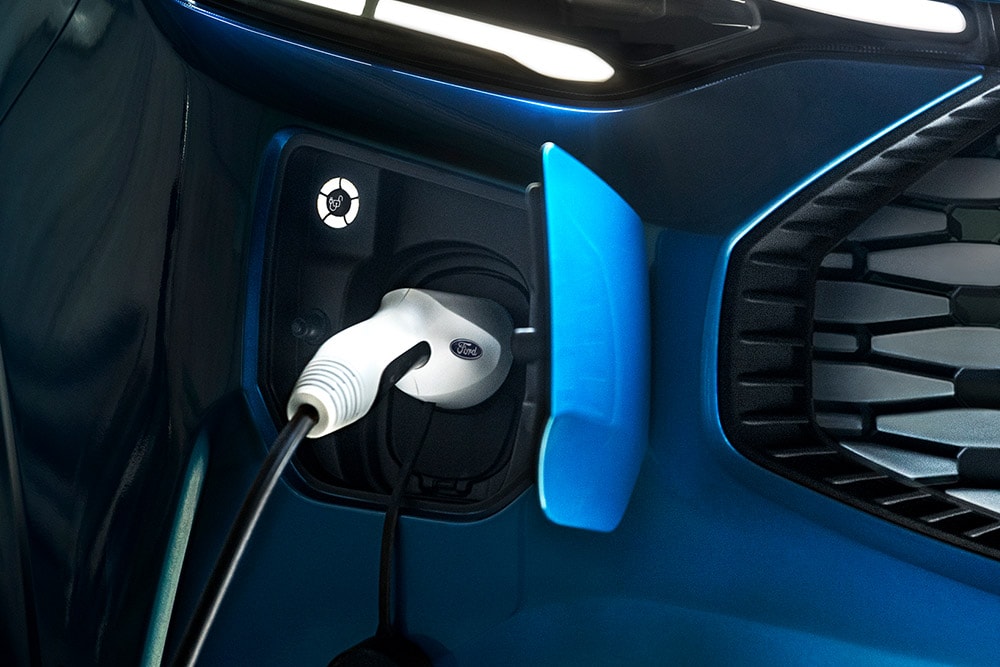 Blue Ford Transit Custom plug-in hybrid being charged.