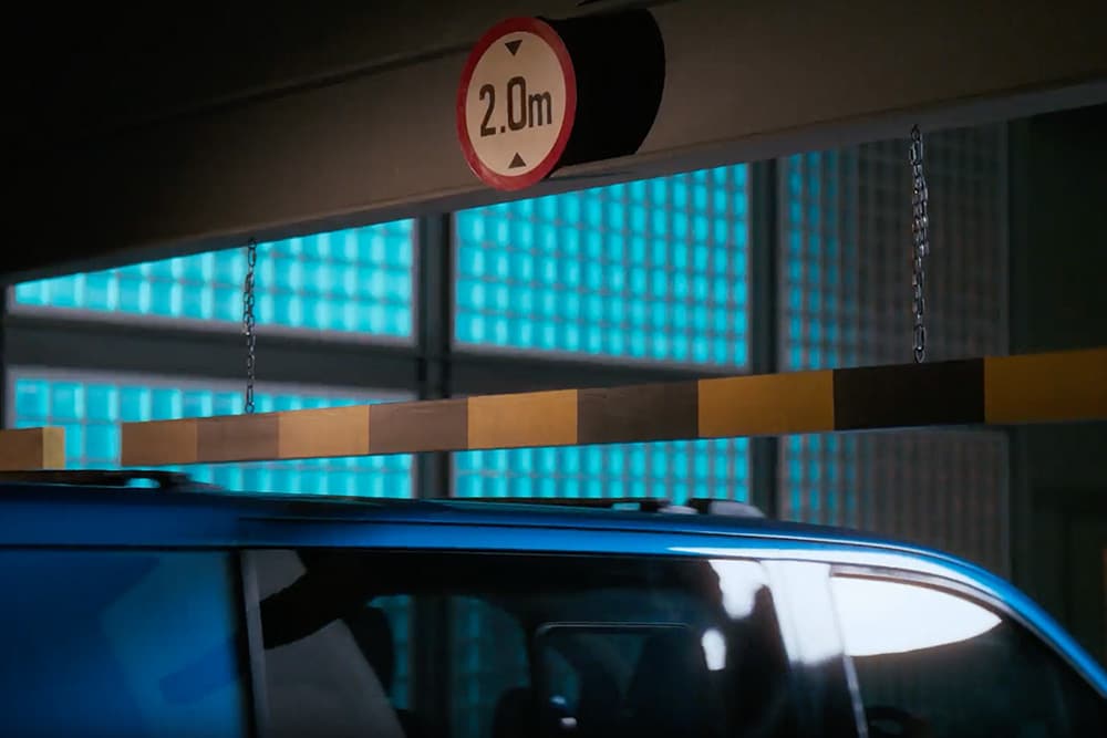 Blue Ford Transit Custom van entering a parking garage.