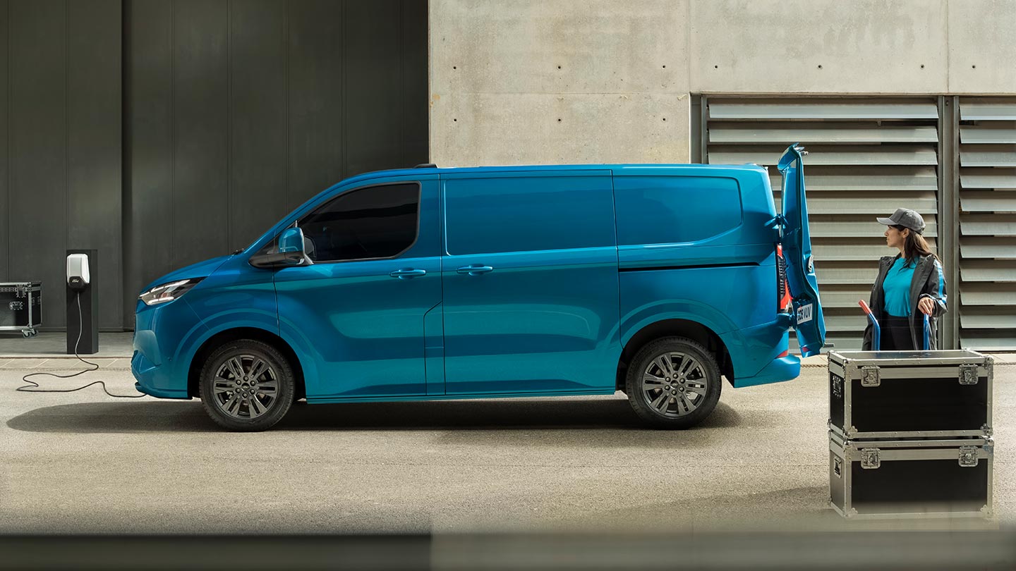 Blue Ford E-Transit Custom electric van charging.