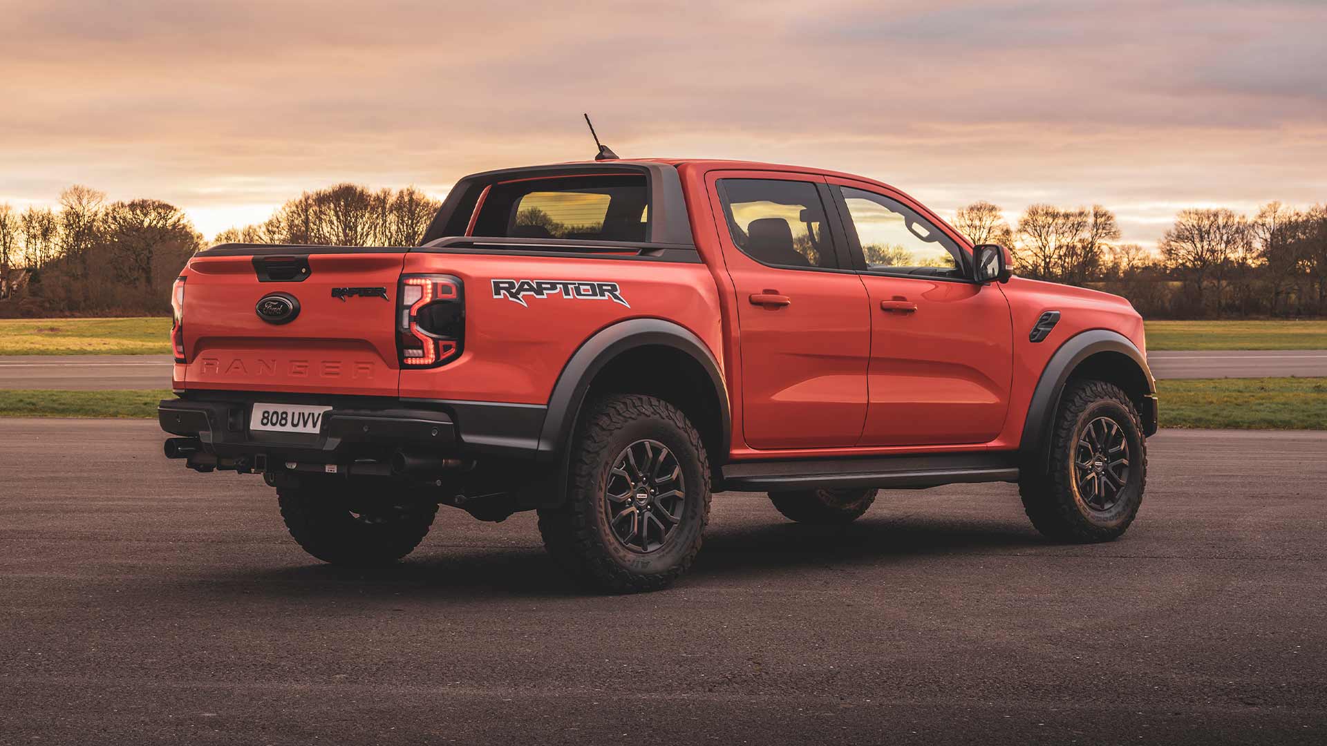 Code Orange Ford Ranger Raptor rear view parked on a track.