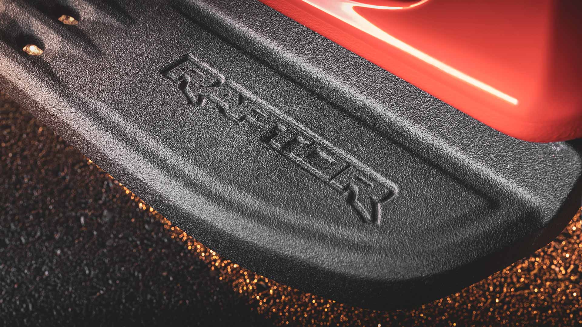 Raptor logo embossed on black side step of Ford Ranger Raptor.
