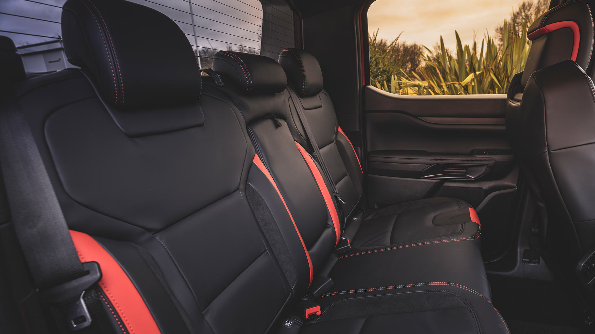 Ford Ranger Raptor rear seats, black with red accents.