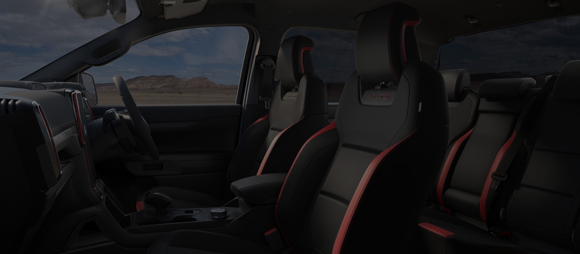 Interior view of black seats with Raptor logo.