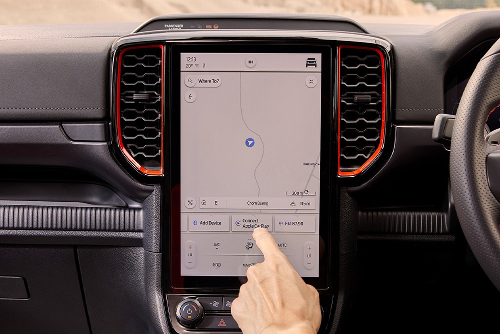 A person selecting options on the Ford Ranger Raptor navigation screen.