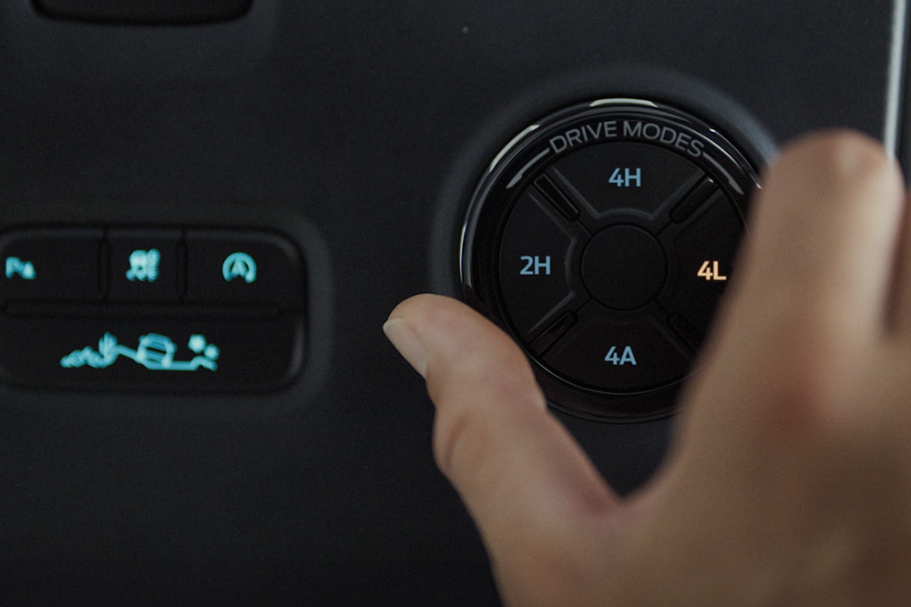 A person selecting drive mode on Ford Ranger Raptor.