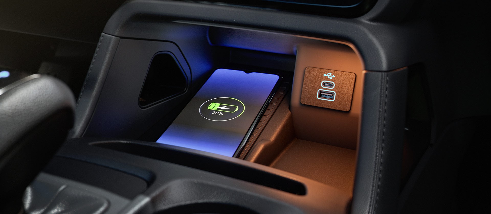 Close up of the Ranger Raptor's interior wireless charger and USB charging port.
