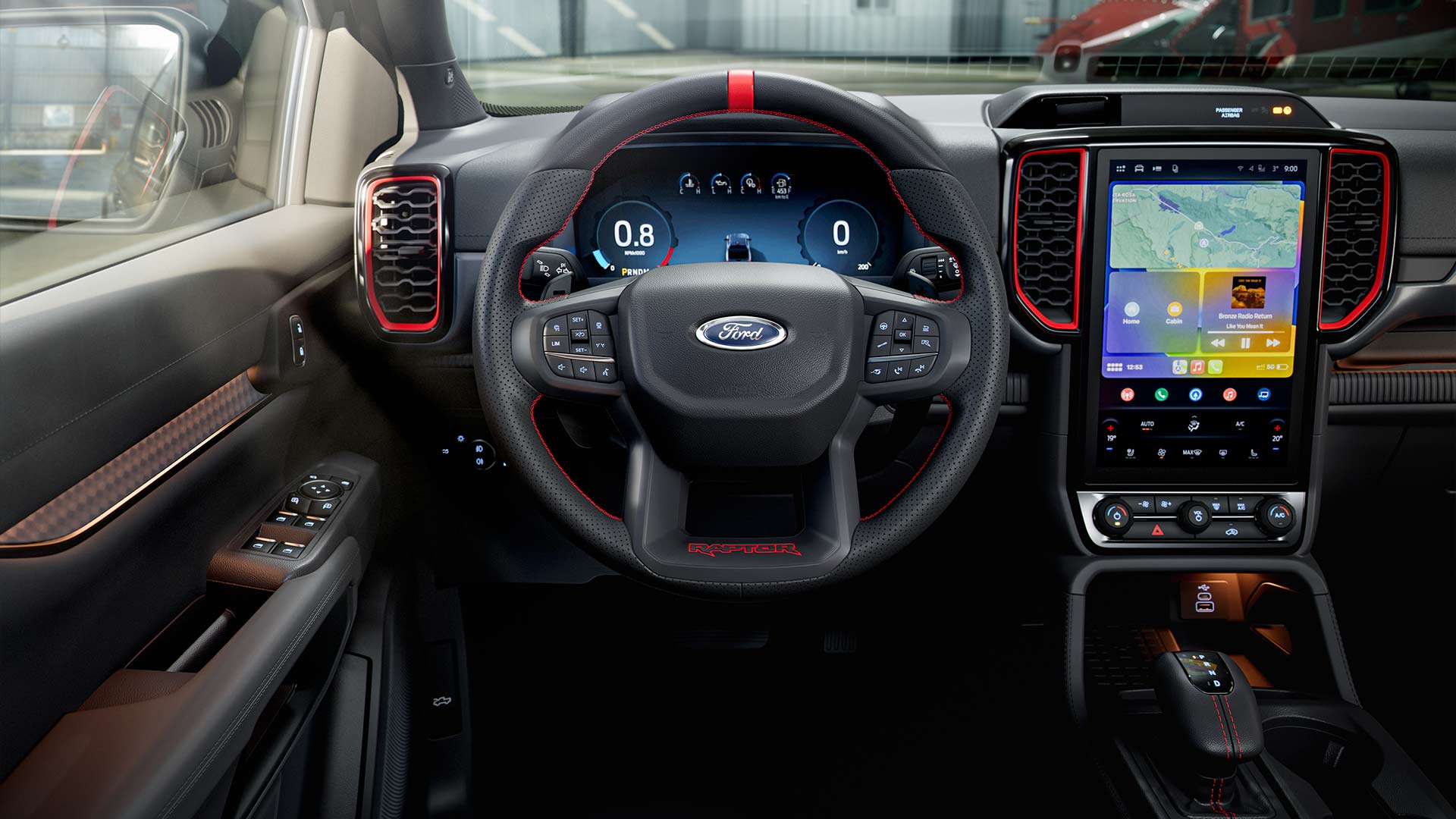 Close up view of the Ford Ranger Raptor's steering wheel and touchscreen.