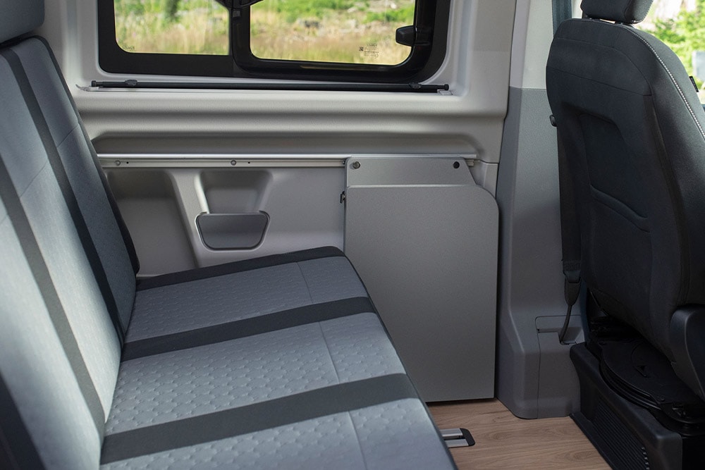 Adaptable heated second row grey seating bench in a Ford Transit Custom Nugget.