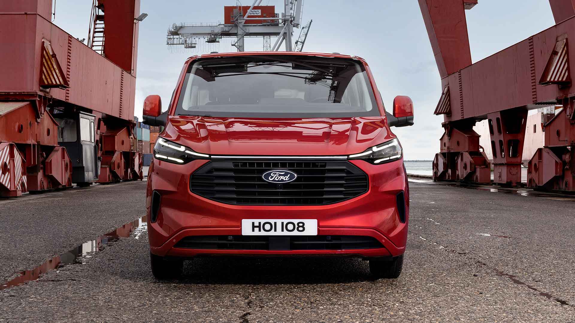 Red Ford Transit Custom van at a port.