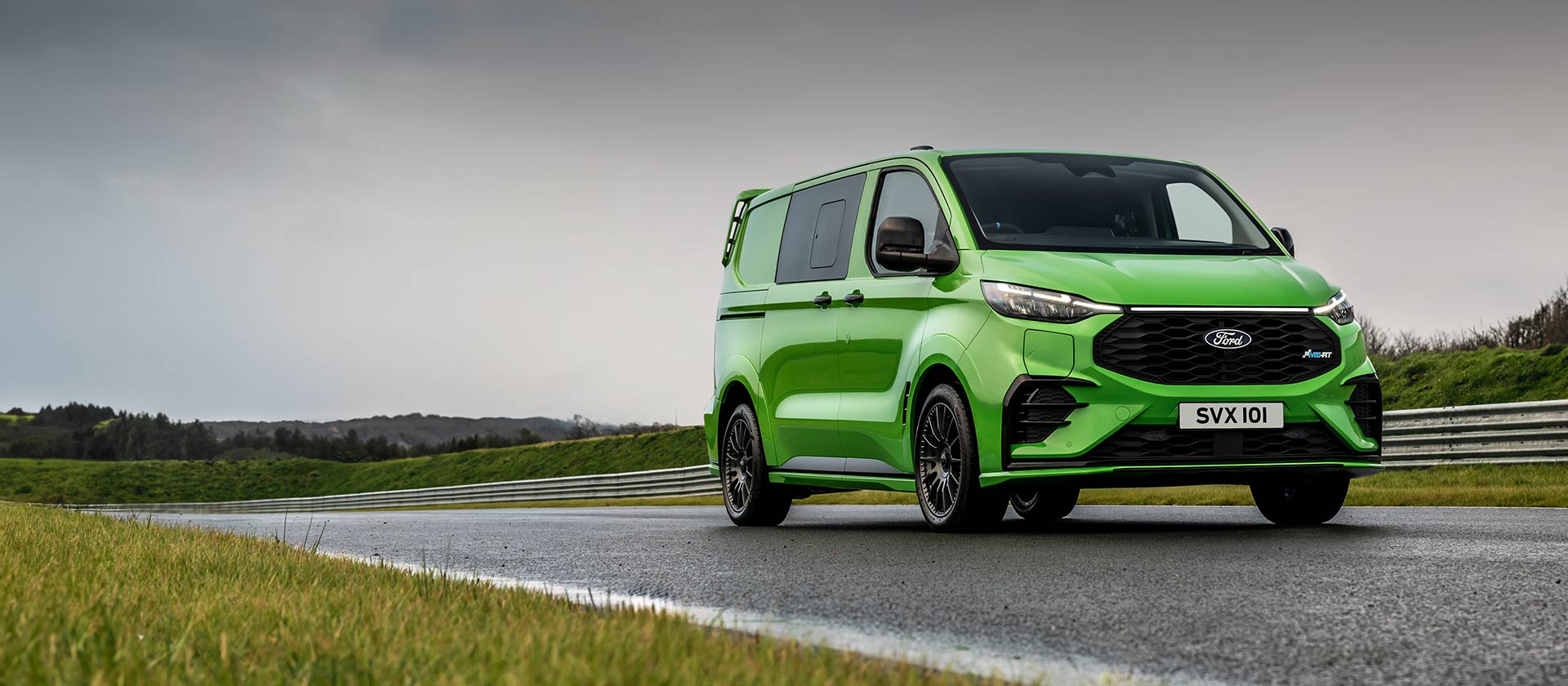 Green Ford Transit Custom MS-RT drives on a track.