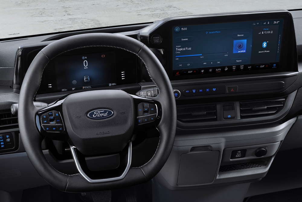 Interior view of a Ford Transit Custom's steering wheel and dashboard.