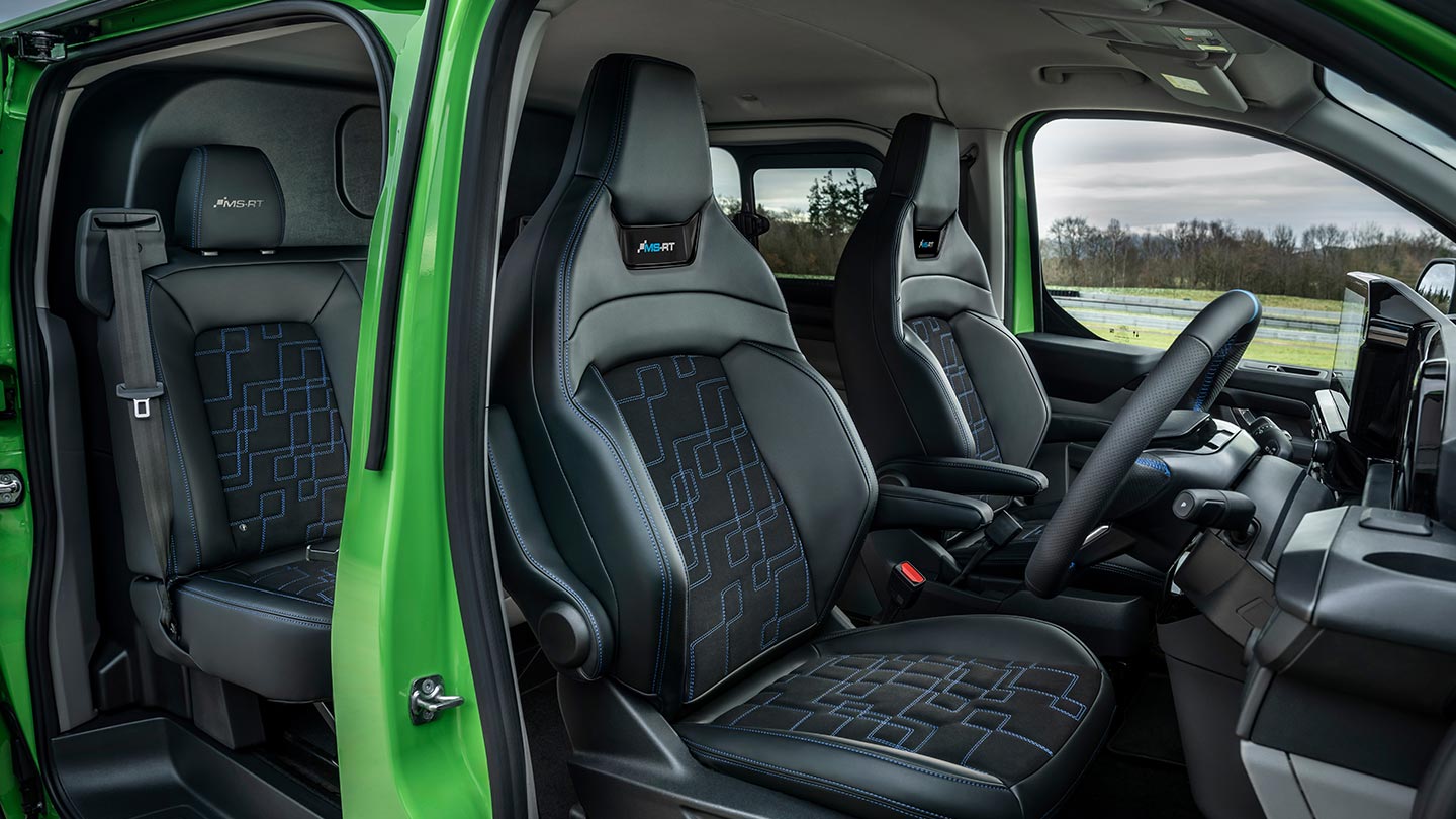 Interior view of a green Ford Transit Custom MS-RT, showing the front seats.