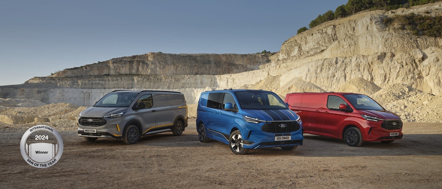 Three Ford Transit Custom Vans in grey, blue and red, parked side by side