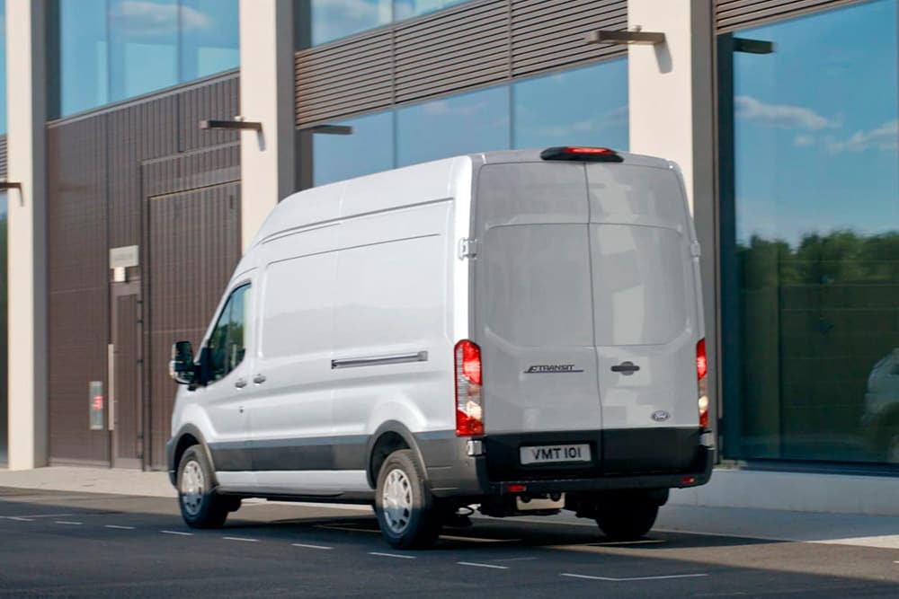 Rear view of a white Ford Transit van parked on a street.