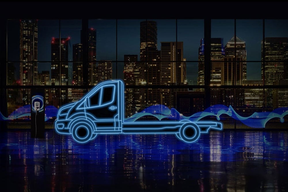 Neon blue outline of a Ford E-Transit Chassis Cab and charging station against a city skyline.