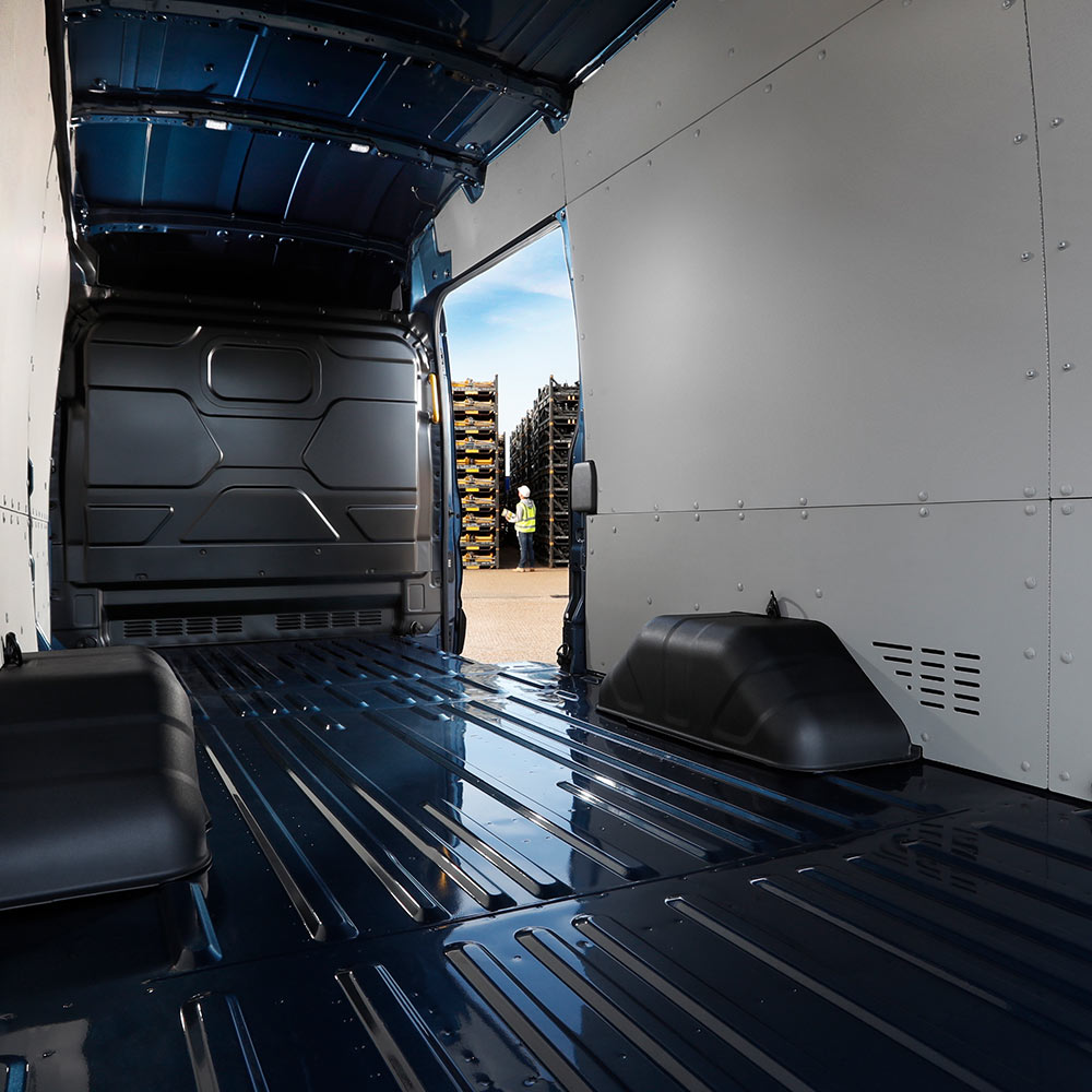 The interior of a Ford E-Transit electric van with an empty cargo space.