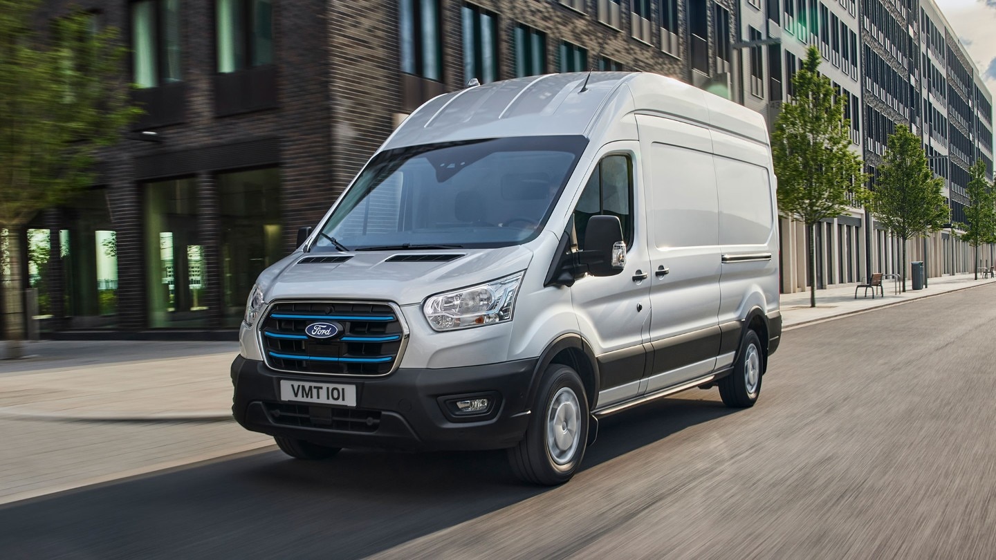Ford E-Transit driving through city 3/4 front view