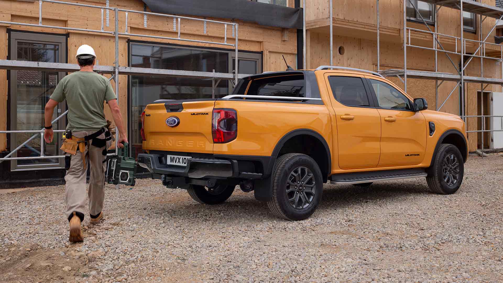 Rear three-quarter view of yellow Ford Ranger Wildtrak Double Cab at a construction site.