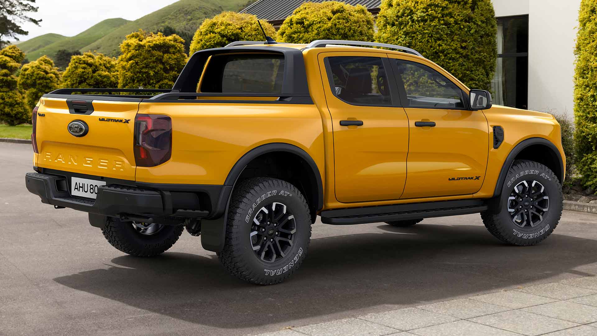 Yellow Ford Ranger Double Cab parked on a paved driveway.