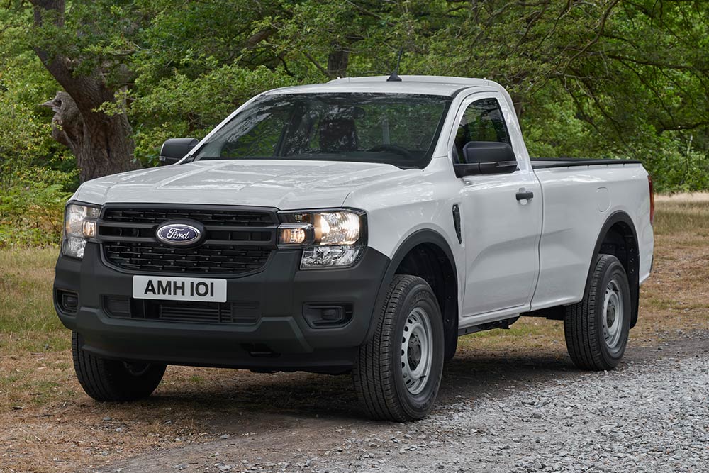 White Ford Ranger Regular Cab parked on a dirt road, front view.