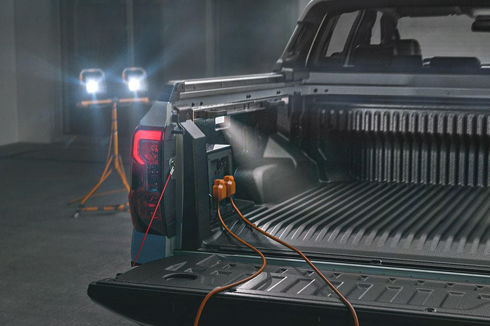 Close-up of the Ford Ranger PHEV’s truck bed powering tools and lighting with Pro Power OnBoard