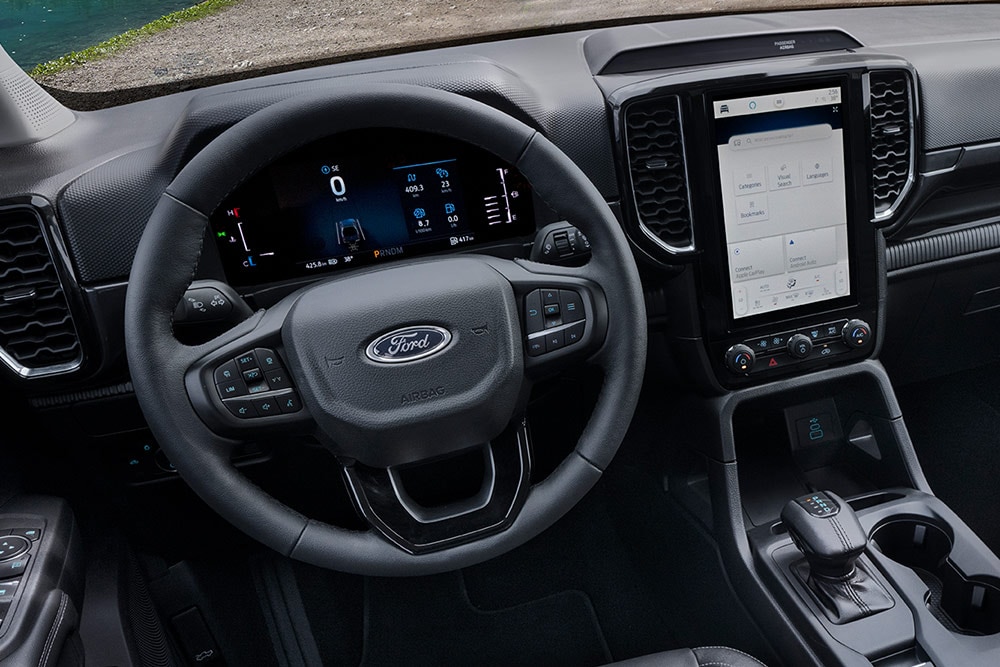 Interior view of the Ford Ranger Wildtrak showing the steering wheel, centre console SYNC™ 4 12-inch touchscreen.