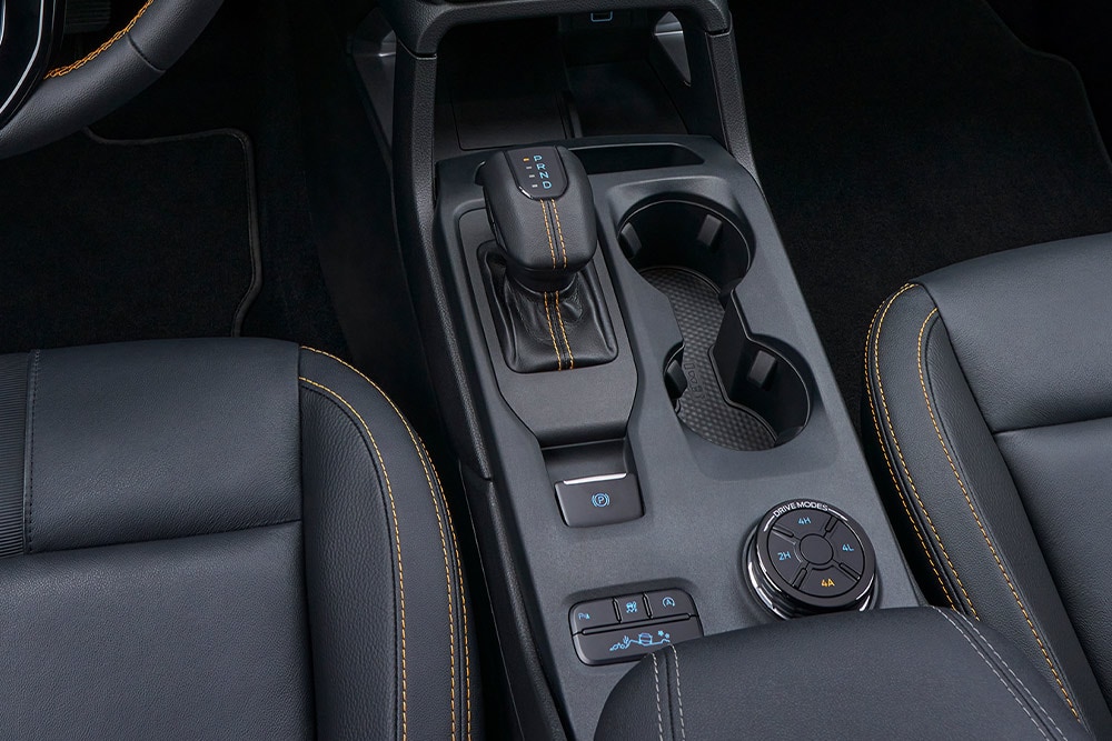 Ranger centre console featuring automatic transmission gear shift, rotary drive-mode selector, and cup holders.