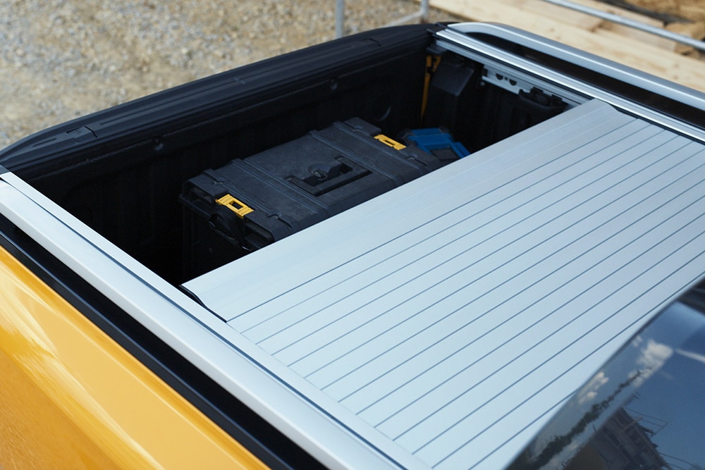 Worker stepping onto the integrated rear  step of the Ford Ranger.