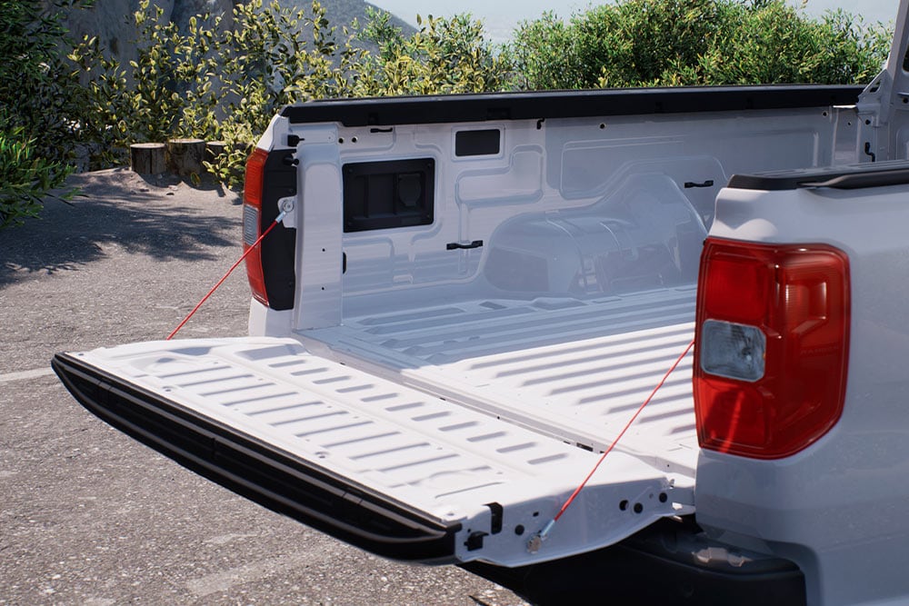 Close-up of the open tailgate of a white Ford Ranger pick-up truck.