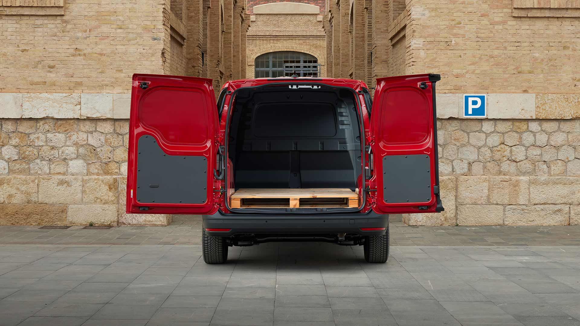 Rear view of Ford Transit Connect, with open rear doors, loaded with construction materials.