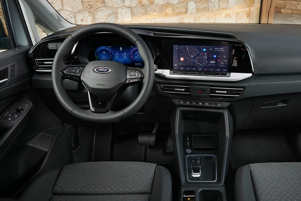 Ford Transit Connect interior showing dashboard, steering wheel, digital cluster and 10-inch touchscreen.
