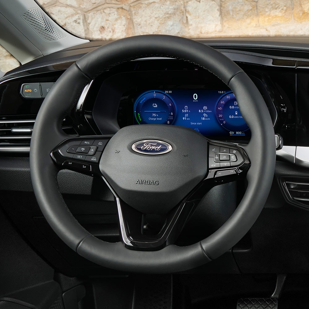 Interior of Ford Transit Connect, showing steering wheel and 10-inch digital instrument cluster.