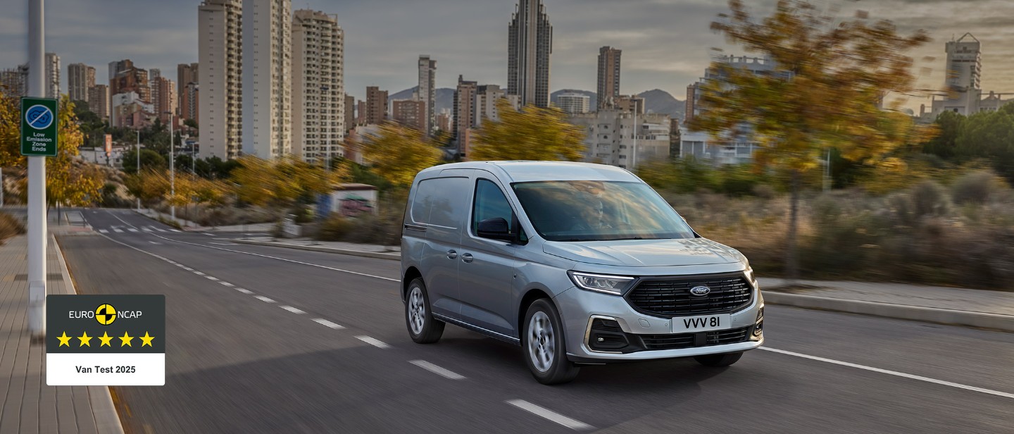 All-New Ford Transit Connect in Stardust Silver drives along a road.