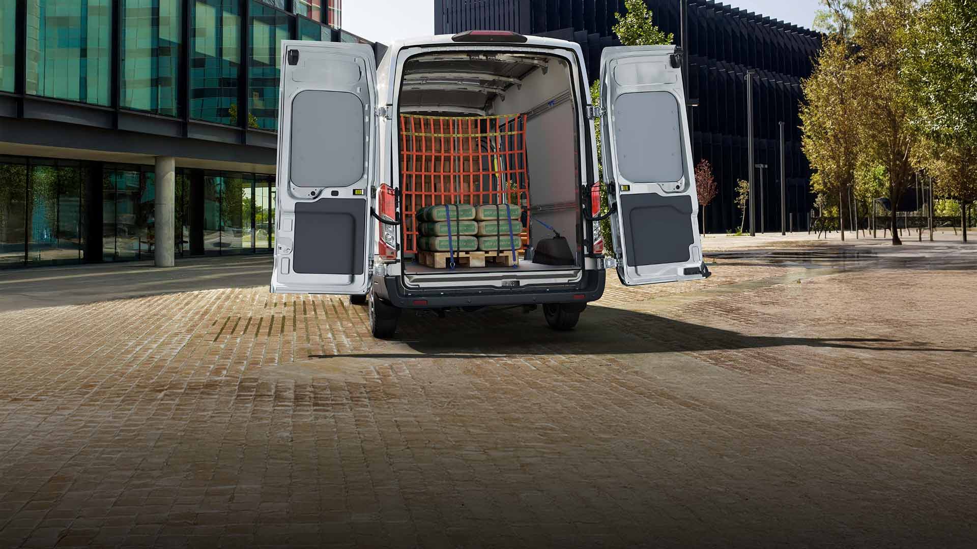 Ford Transit Van with open rear doors, cargo visible.