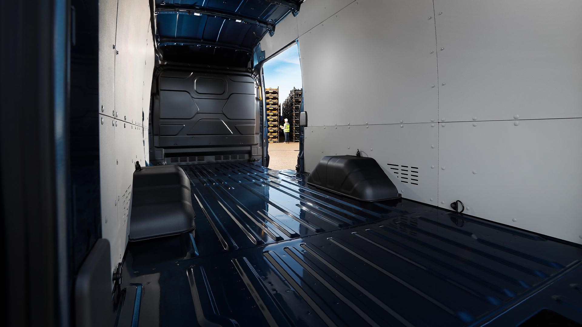 Interior view of an empty cargo area of a Ford Transit Van.
