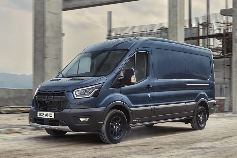 Ford Transit Van with optional Trail pack driving on an industrial estate. 
