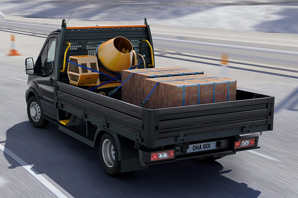 Ford Transit Chassis Cab driving with cargo in the back.