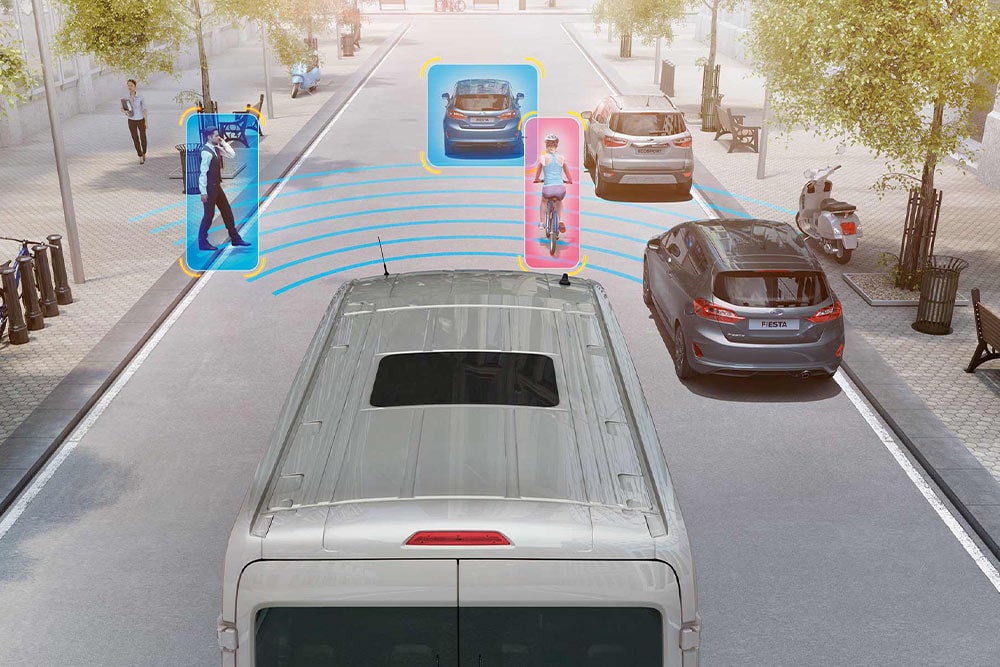 Ford Transit Van with advanced safety features detecting pedestrians and vehicles.